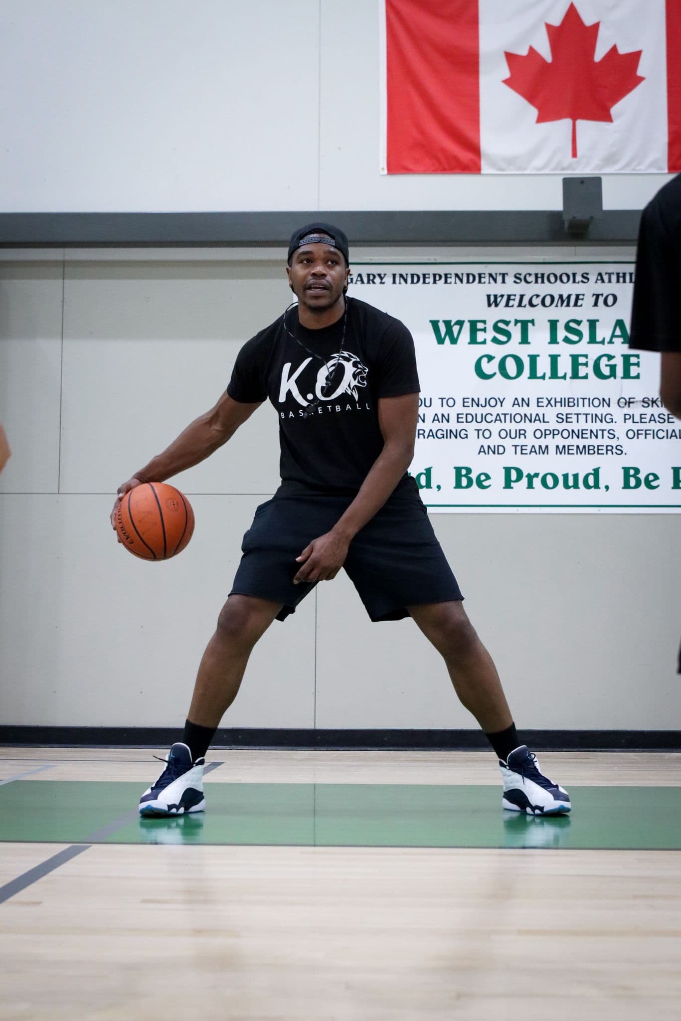 Kenny Otieno dribbling a basketball on court